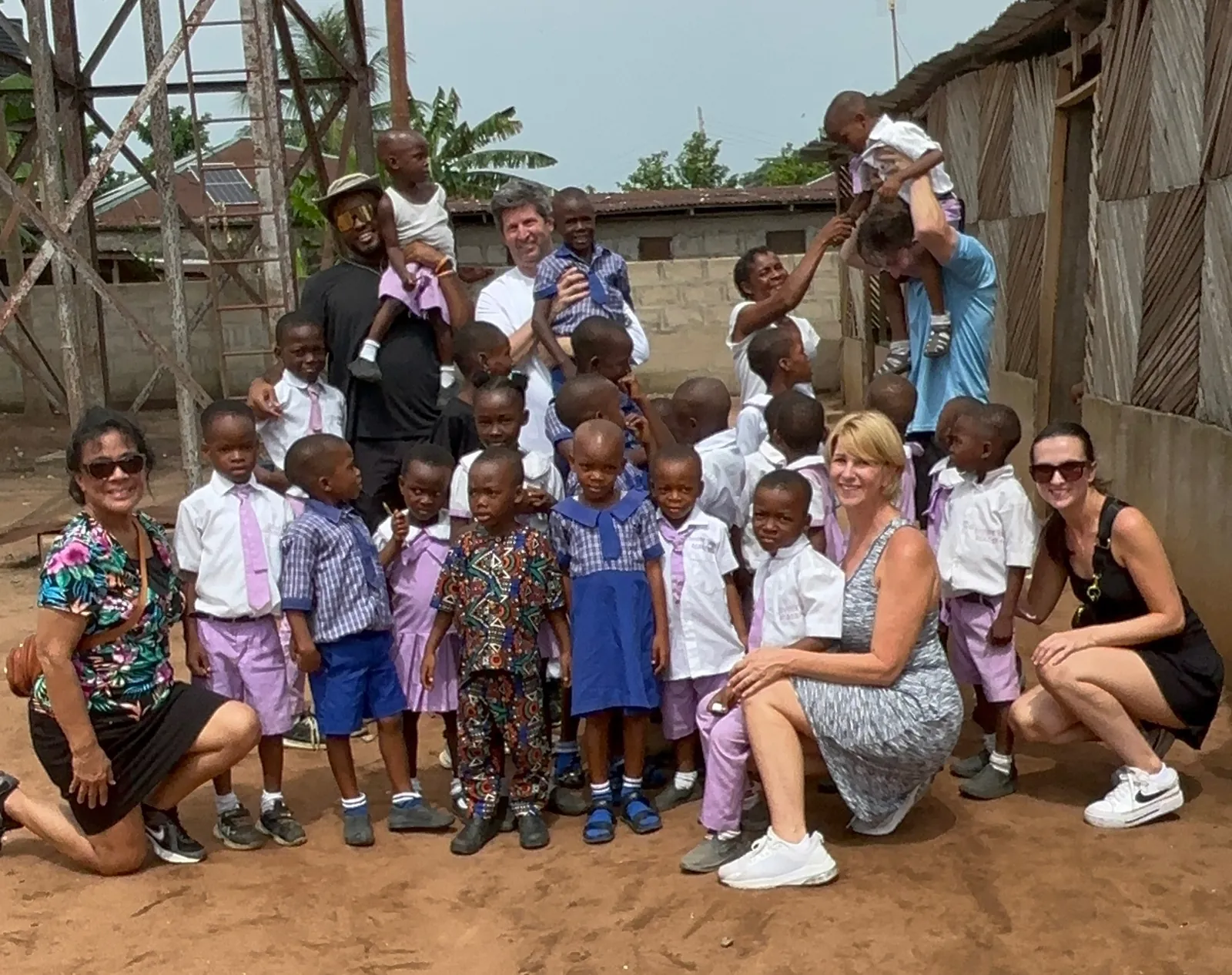 A Hands 4Life team with children at a school